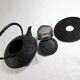 Antique cast iron teapot decorated