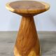 Minimalist side table in solid suar wood with conical legs.