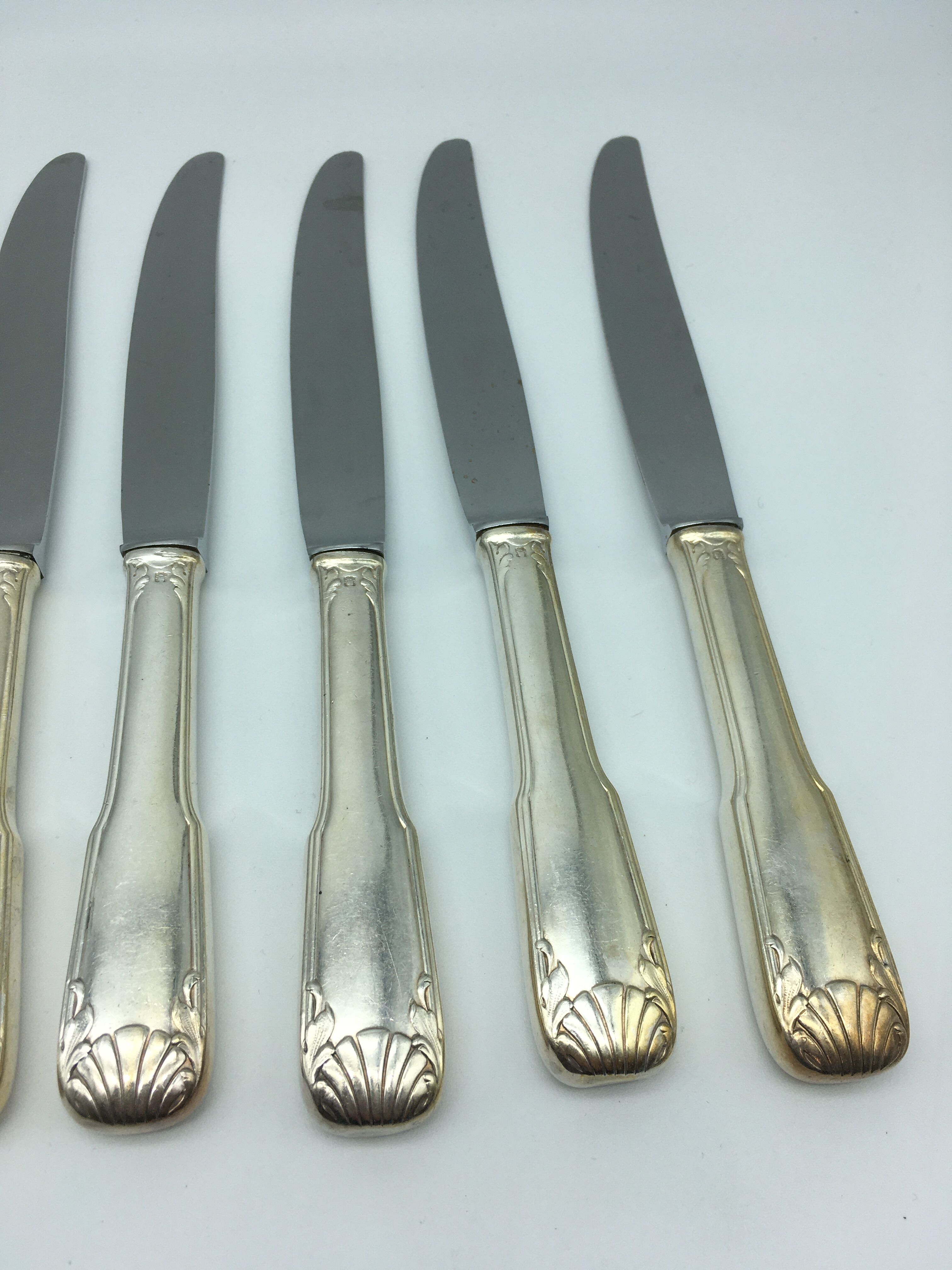 12 silver metal knives.