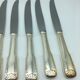 12 silver metal knives.