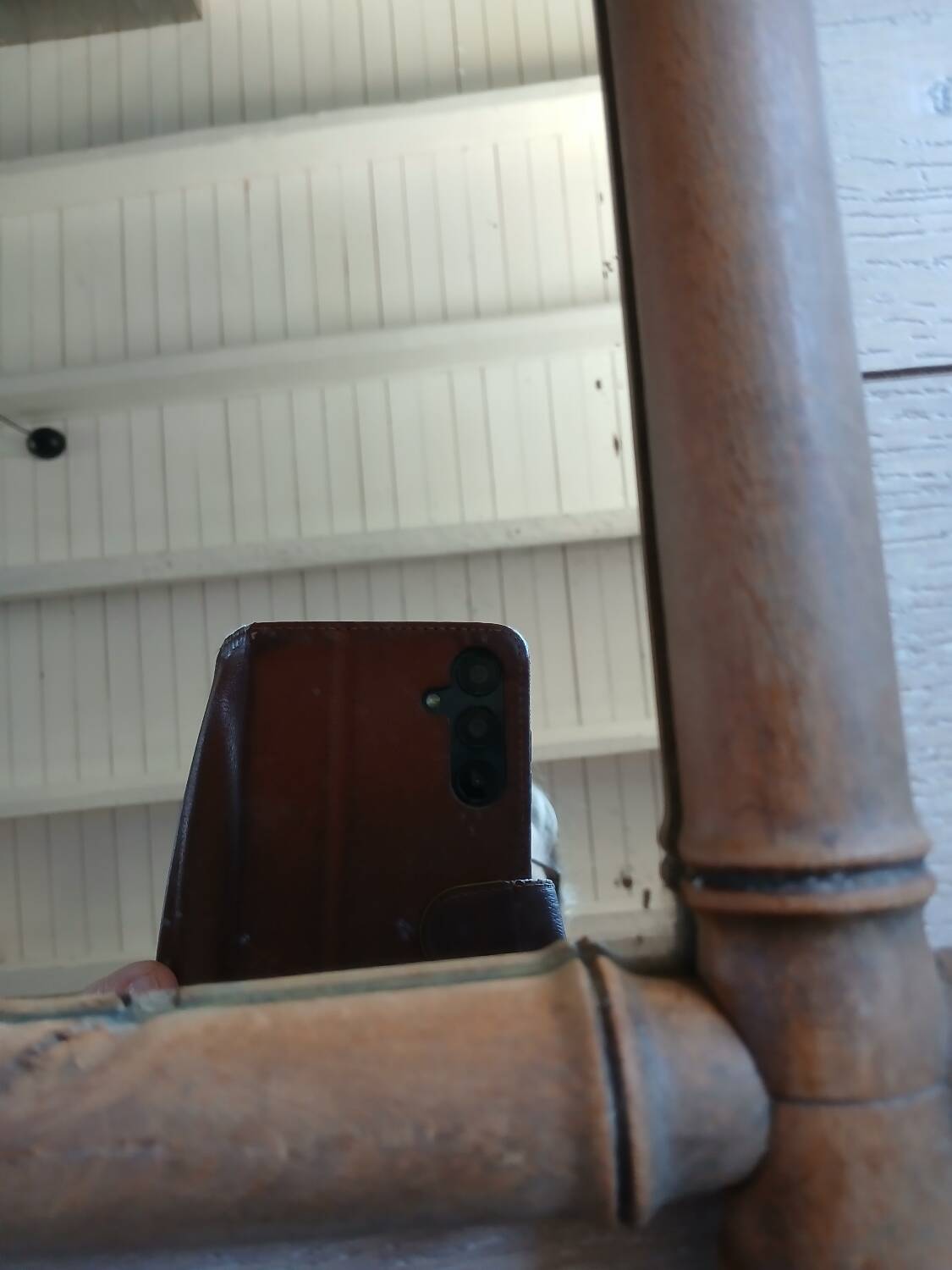 Antique wall mirror with a wooden frame