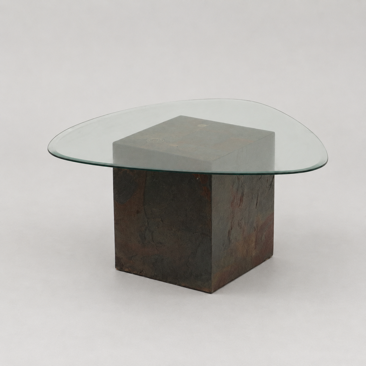 Unique design coffee table with natural stone base and organic glass top