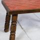 Brutalist coffee table in orange ceramic and solid wood.