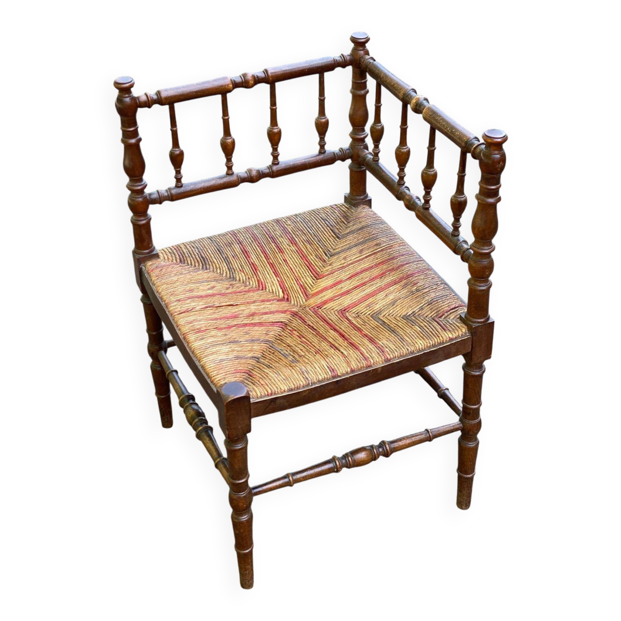 19th-century solid wood corner chair with red and blue rush seating.