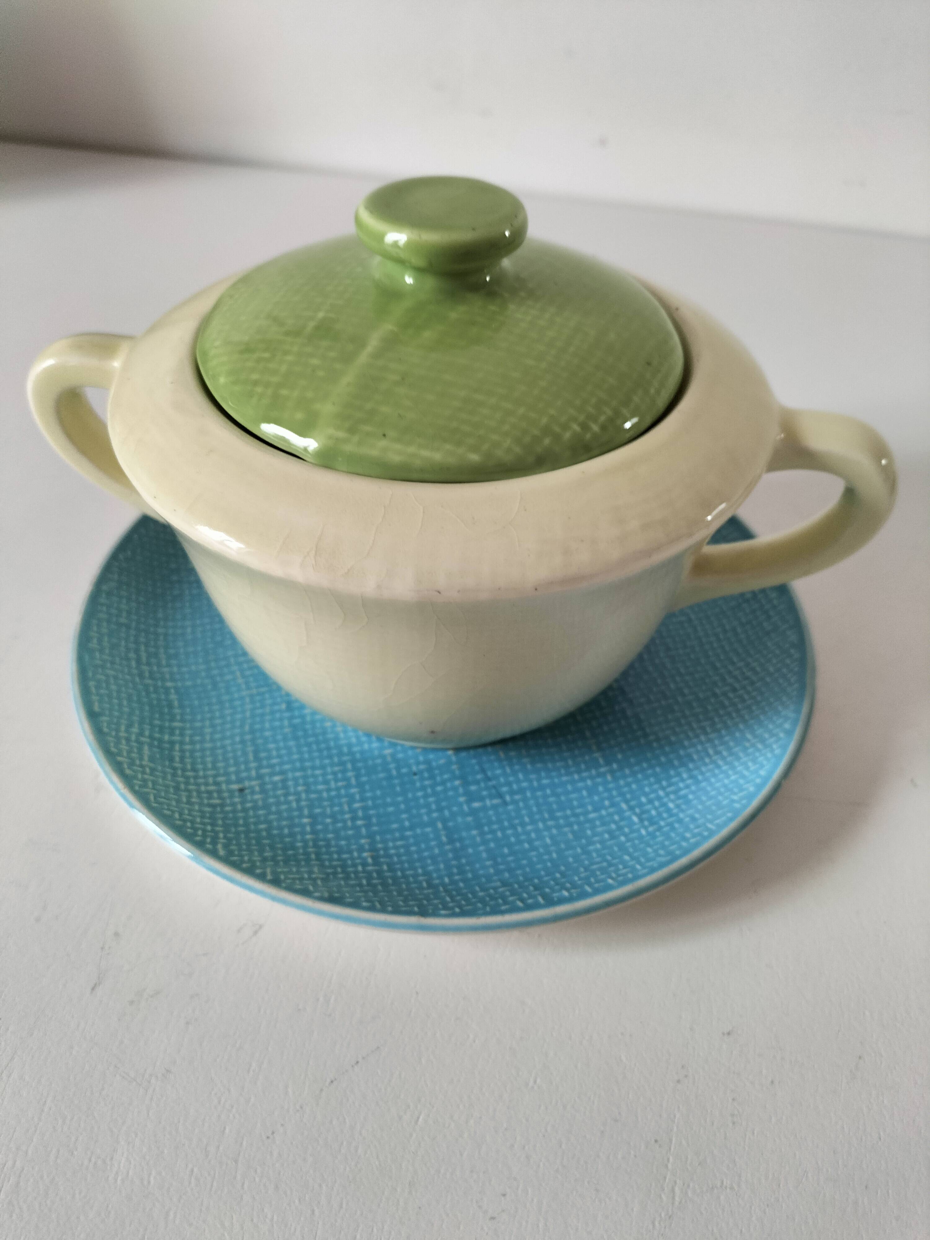 Two sugar bowls and a textured plate in turquoise and green Salins earthenware.