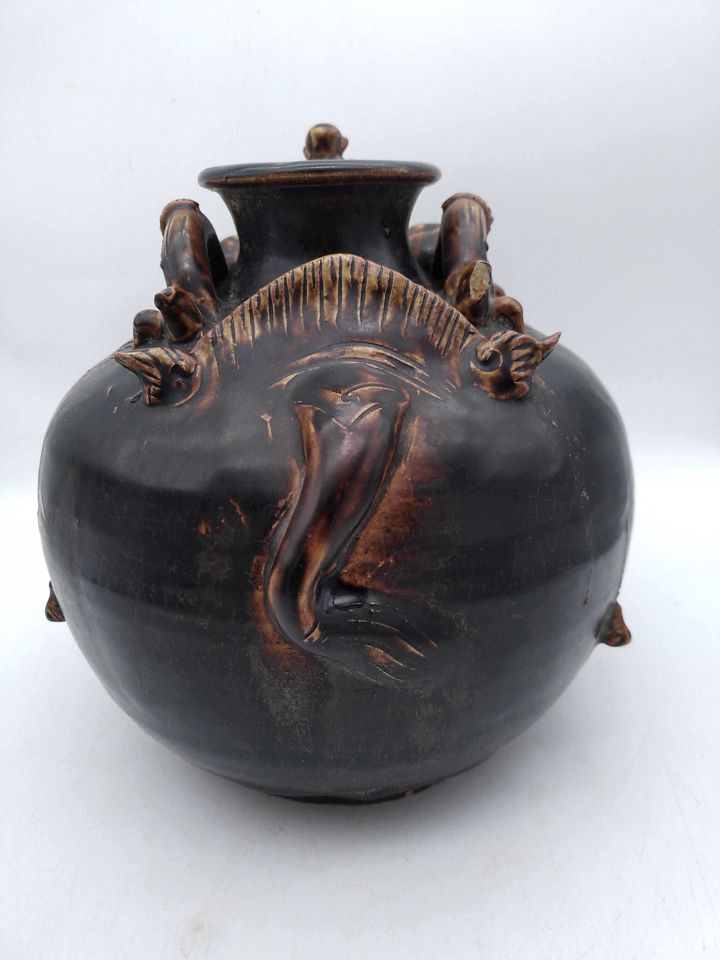 Antique Khmer ceramic vase. With elephant decoration.