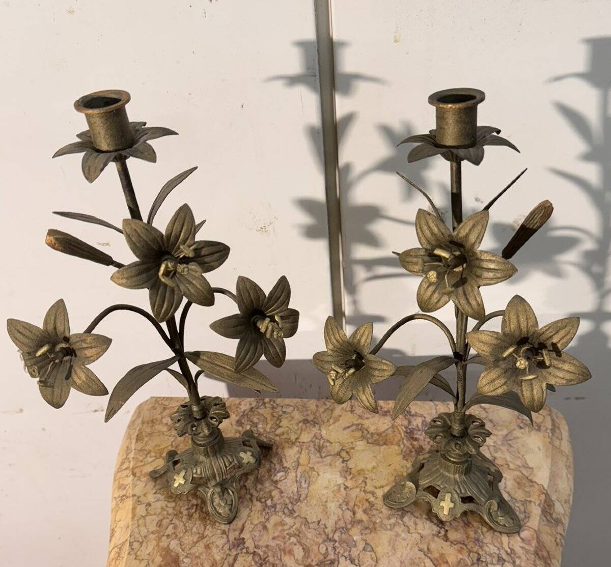 Pair of church candlesticks in bronze with floral decorations.