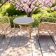 Vintage rattan garden furniture with cushions.