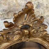 Old oval frame in wood and gilded stucco