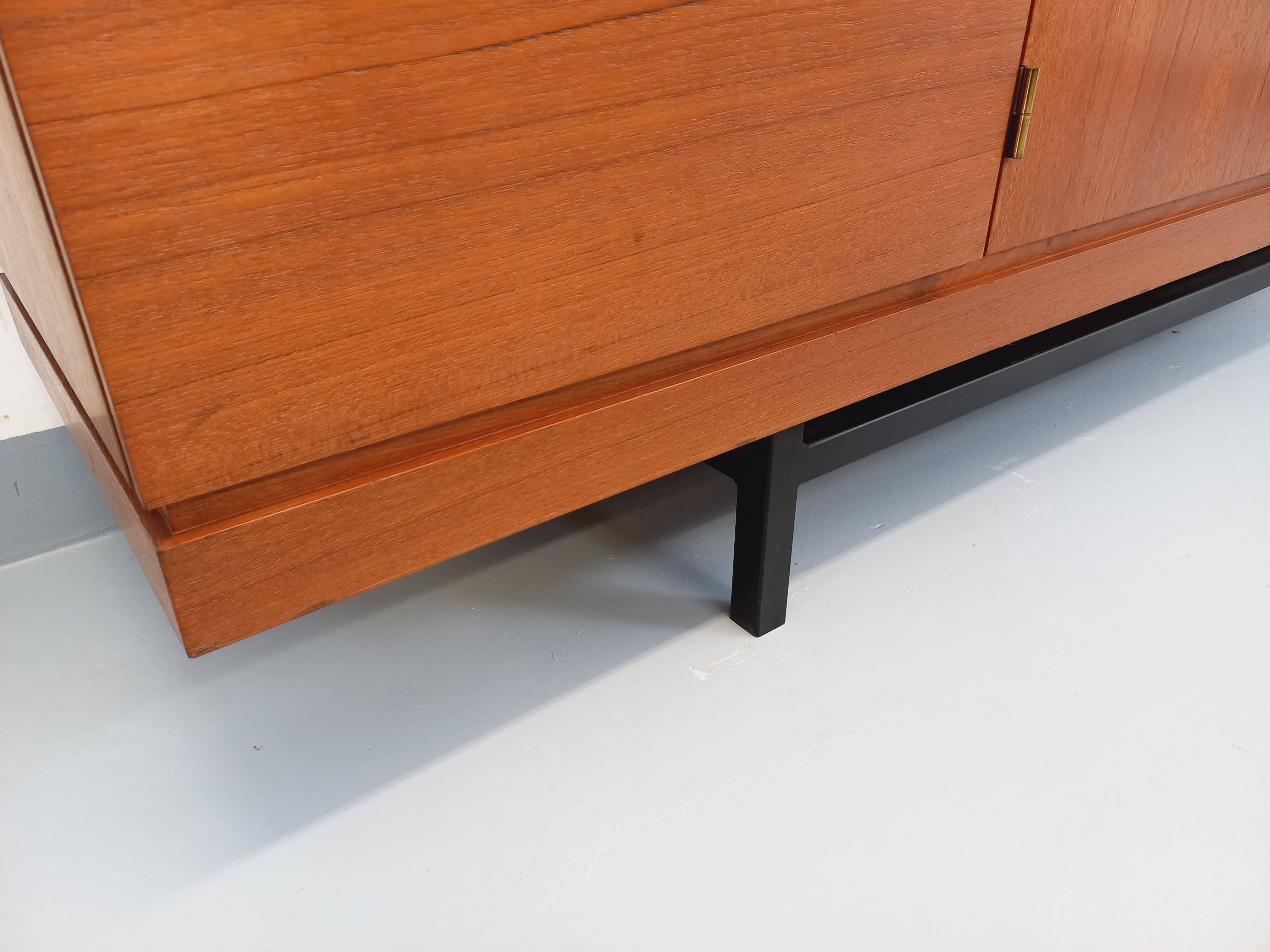 High Scandinavian modernist vintage sideboard in teak and black metal.