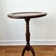 Small tripod wooden table with a vintage round top -