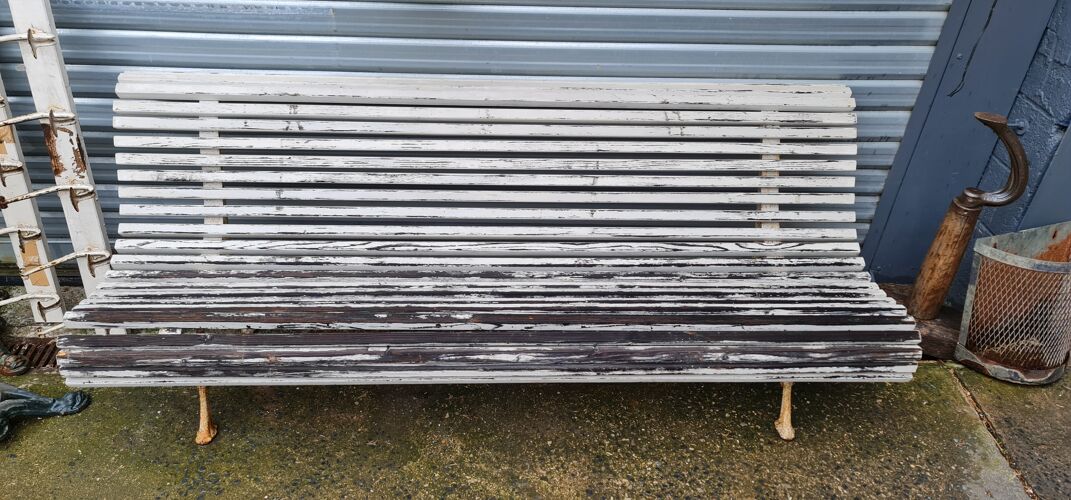 Large bench with old white garden slats