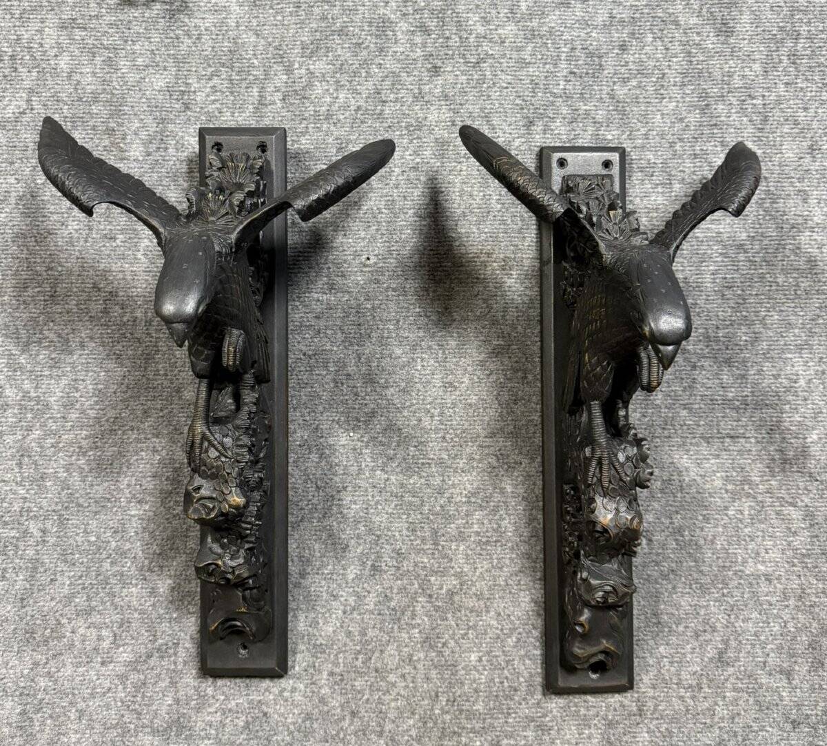 Rare pair of patinated wooden wall consoles, featuring two eagles with outstretched wings.