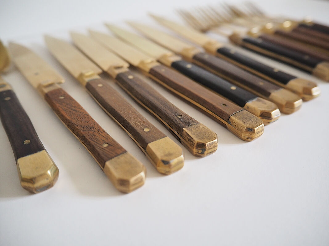 Set of old dessert cutlery in wood and brass