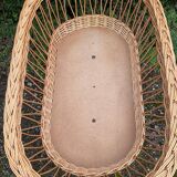 Vintage wicker cradle on casters
