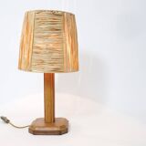 Lamp base in saddle stitched leather and raffia lampshade.
