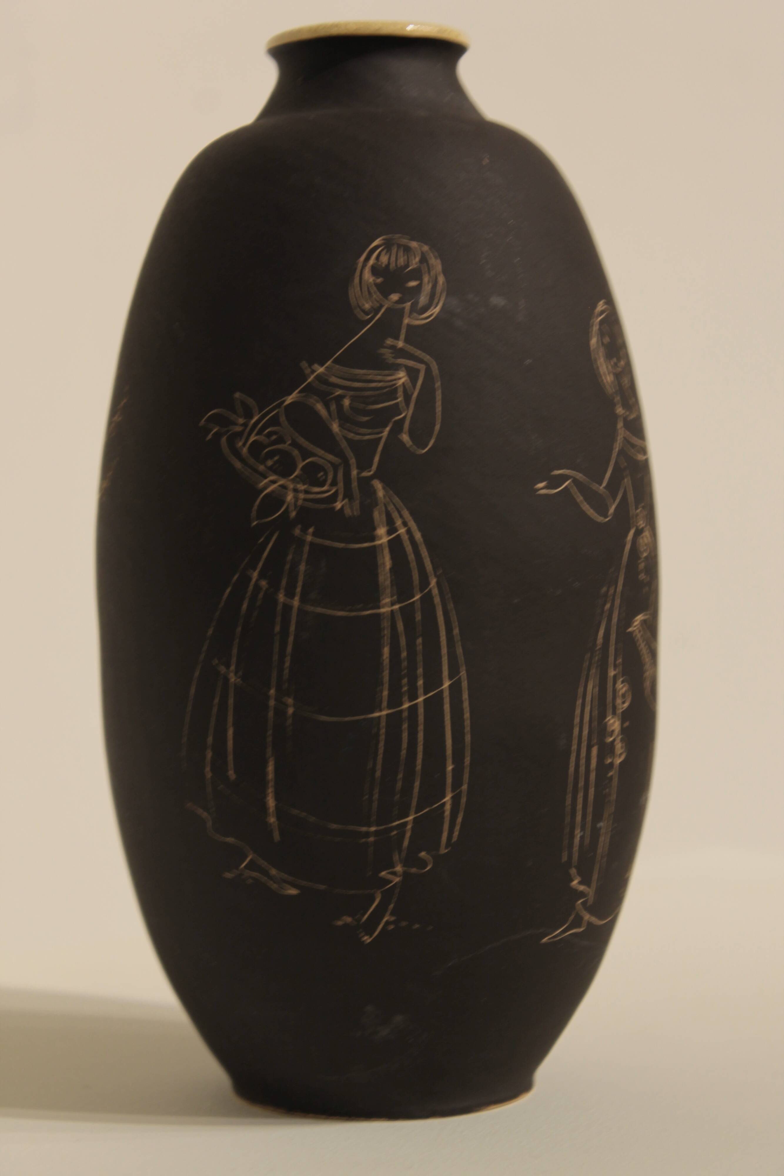 Ceramic vase decorated with women and a tree.