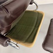 Vintage leather reclining armchair and its 1970s designer ottoman.