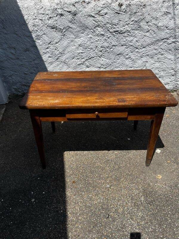 Old wooden table with a drawer