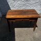 Old wooden table with a drawer