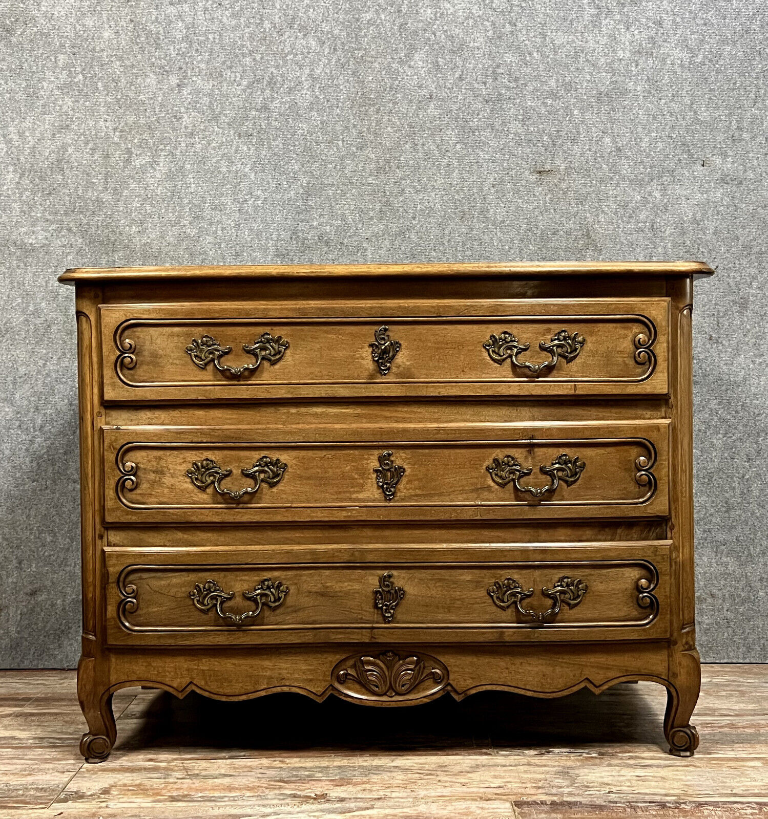 Curved Louis XV style chest of drawers in solid wood with a light patina