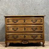 Curved Louis XV style chest of drawers in solid wood with light patina
