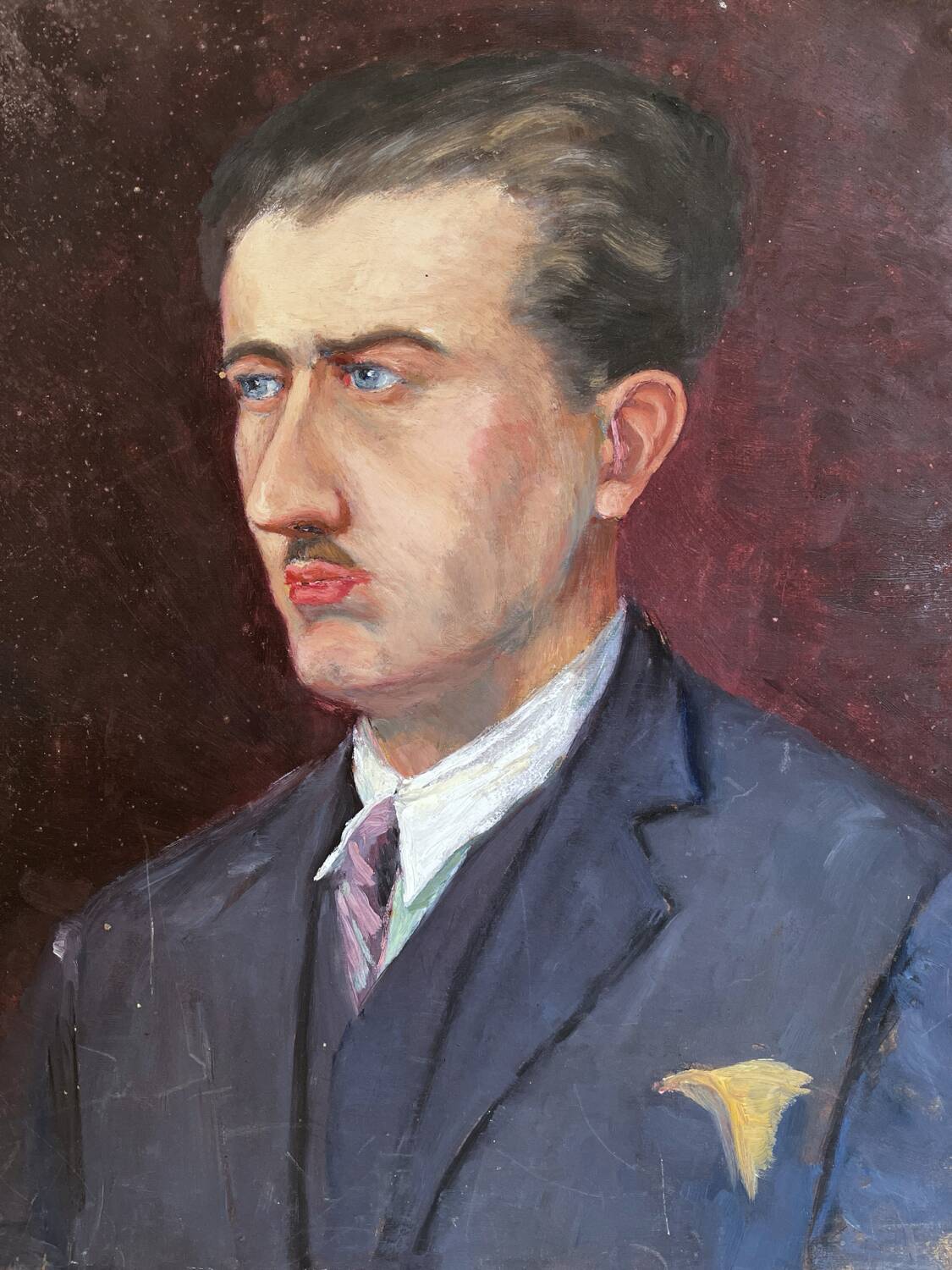 Old oil painting on cardboard portrait of a man in a blue suit