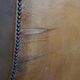 Old wingback armchair made of sheep leather in a correct condition