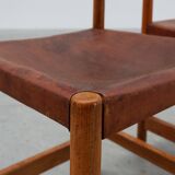 Pair of wood and leather Spanish chairs by Jordi Vilanova, ca. 1960