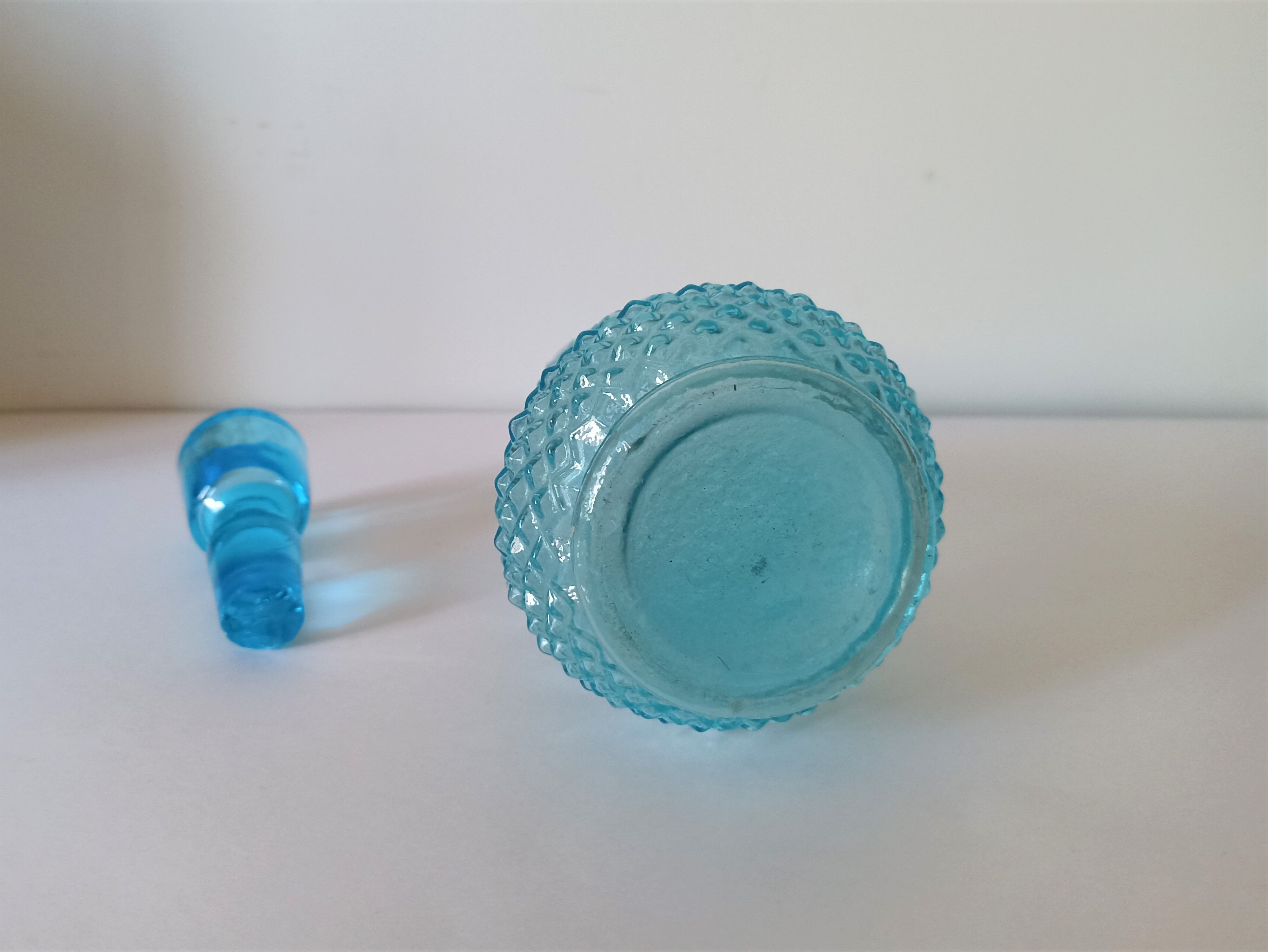 Old turquoise blue molded glass liqueur bottle and its cap