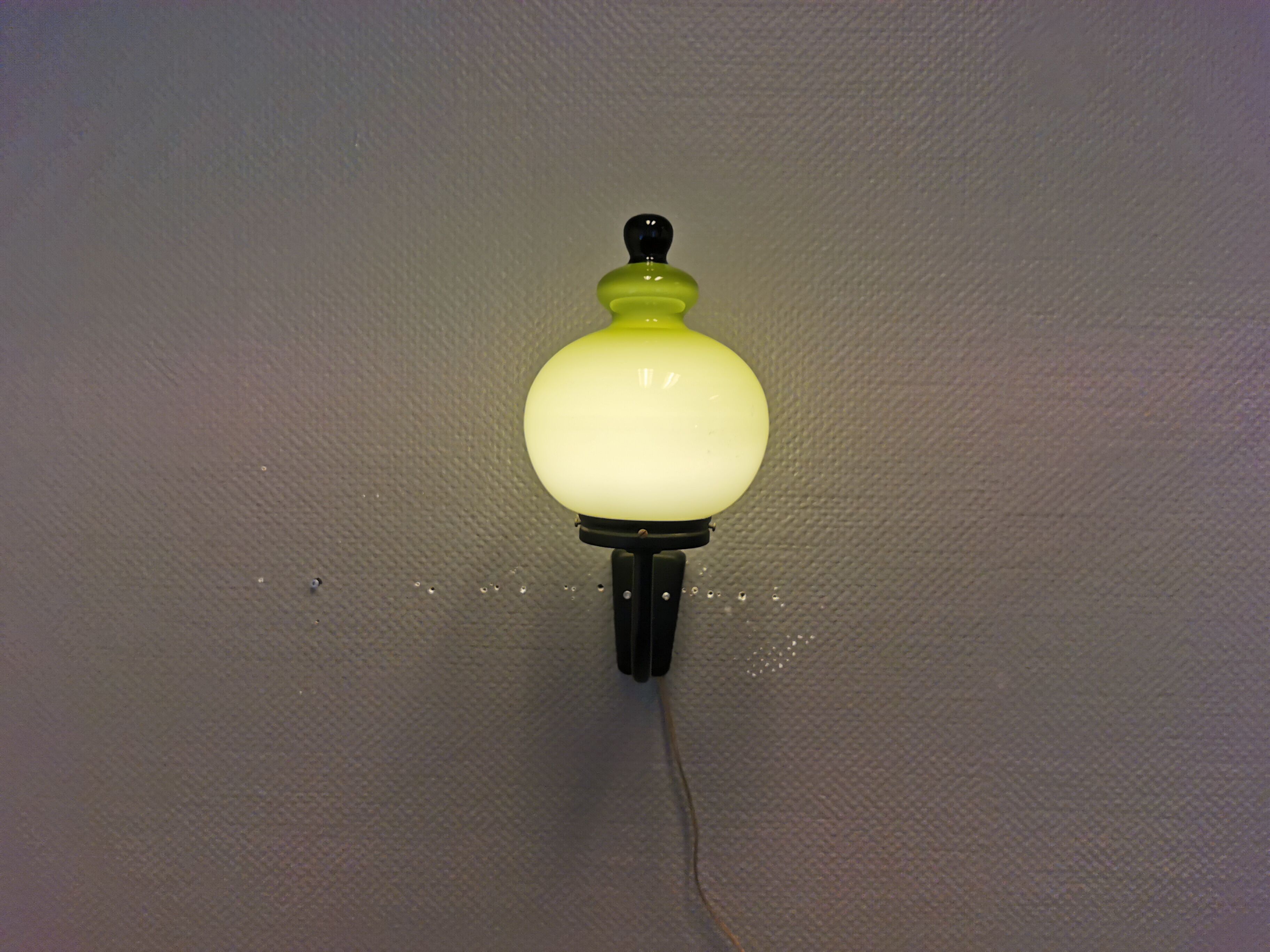 Wall light, made in black metal frame with olive green glass shade