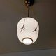 Pair of opaline globe pendant lights with stylized decoration, 1950s