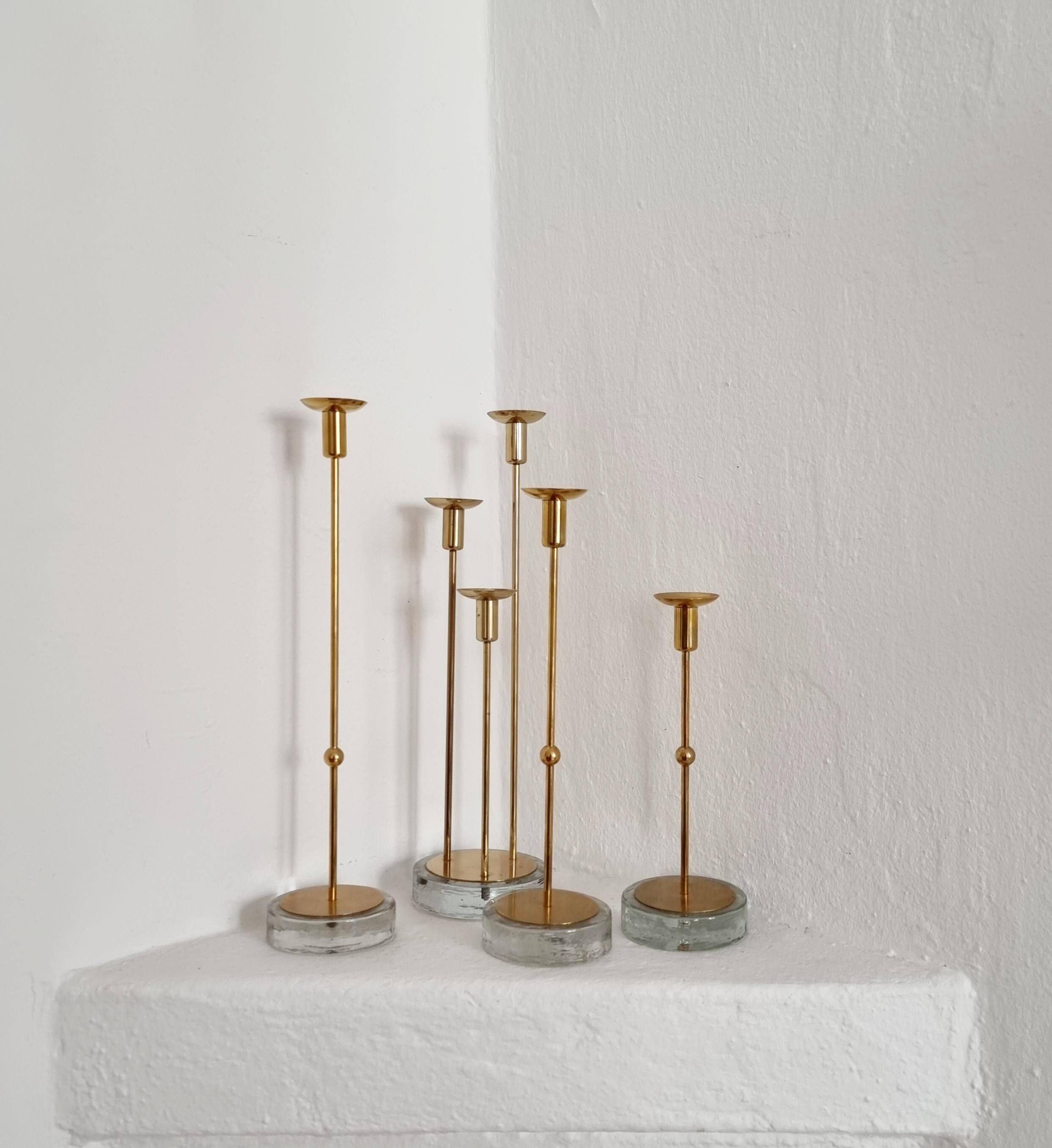 Gunnar Ander, four candlesticks, brass and glass, Ystad Metall, Swedish modern.