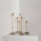 Gunnar Ander, four candlesticks, brass and glass, Ystad Metall, Swedish modern.
