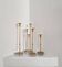 Gunnar Ander, four candlesticks, brass and glass, Ystad Metall, Swedish modern.