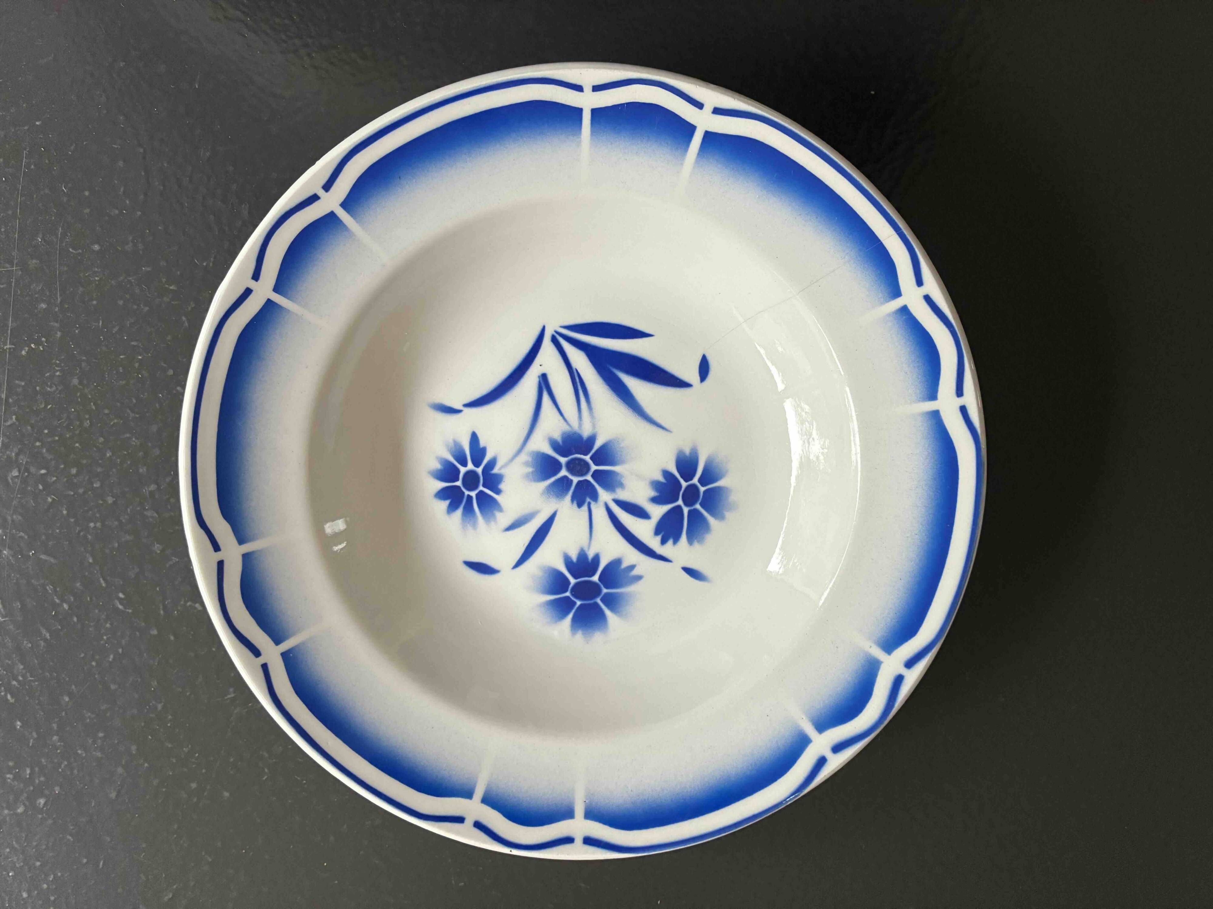 Set of 9 vintage deep plates with blue patterns.