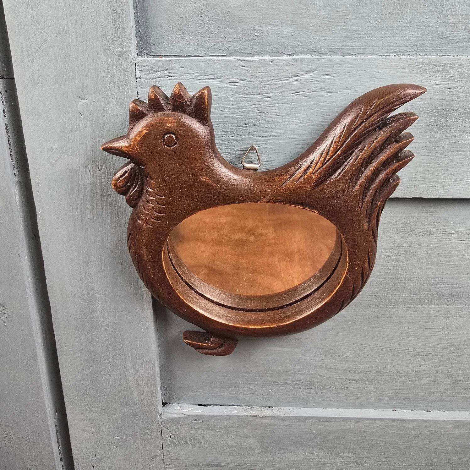 Vintage carved wooden chicken-shaped wall mirror.