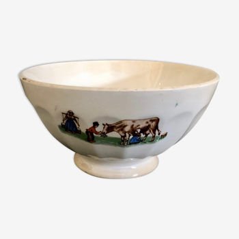 Old bowl decorated with a farmer and her cow
