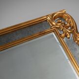 Richly decorated wall mirror in resin with golden ornaments and smoked mirror glass panels, Belgium,