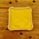 Yellow ceramic trivet and bottle coaster with vintage painted decoration.
