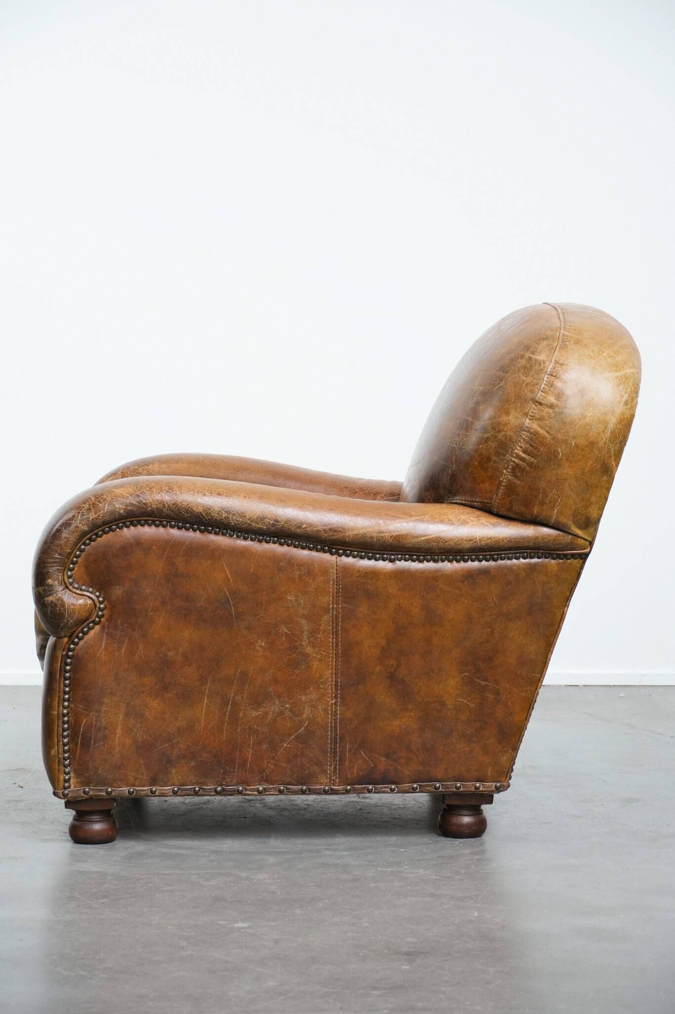 Charming and comfortable vintage armchair in grained cowhide leather with character