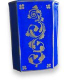 Perfume bottle in porcelain of old paris blue background