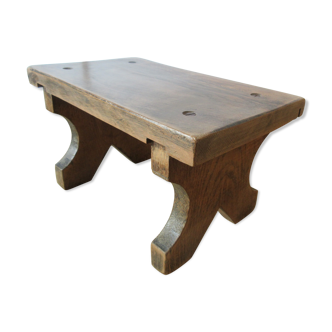 Small old bench (low stool) in solid oak brutalist spirit