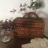 Bagged suitcase in braided wicker and wood