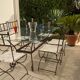 Table de terrasse plateau en verre + 6 chaises en fer forgé