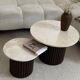Round nesting coffee table in travertine and dark fluted wood.