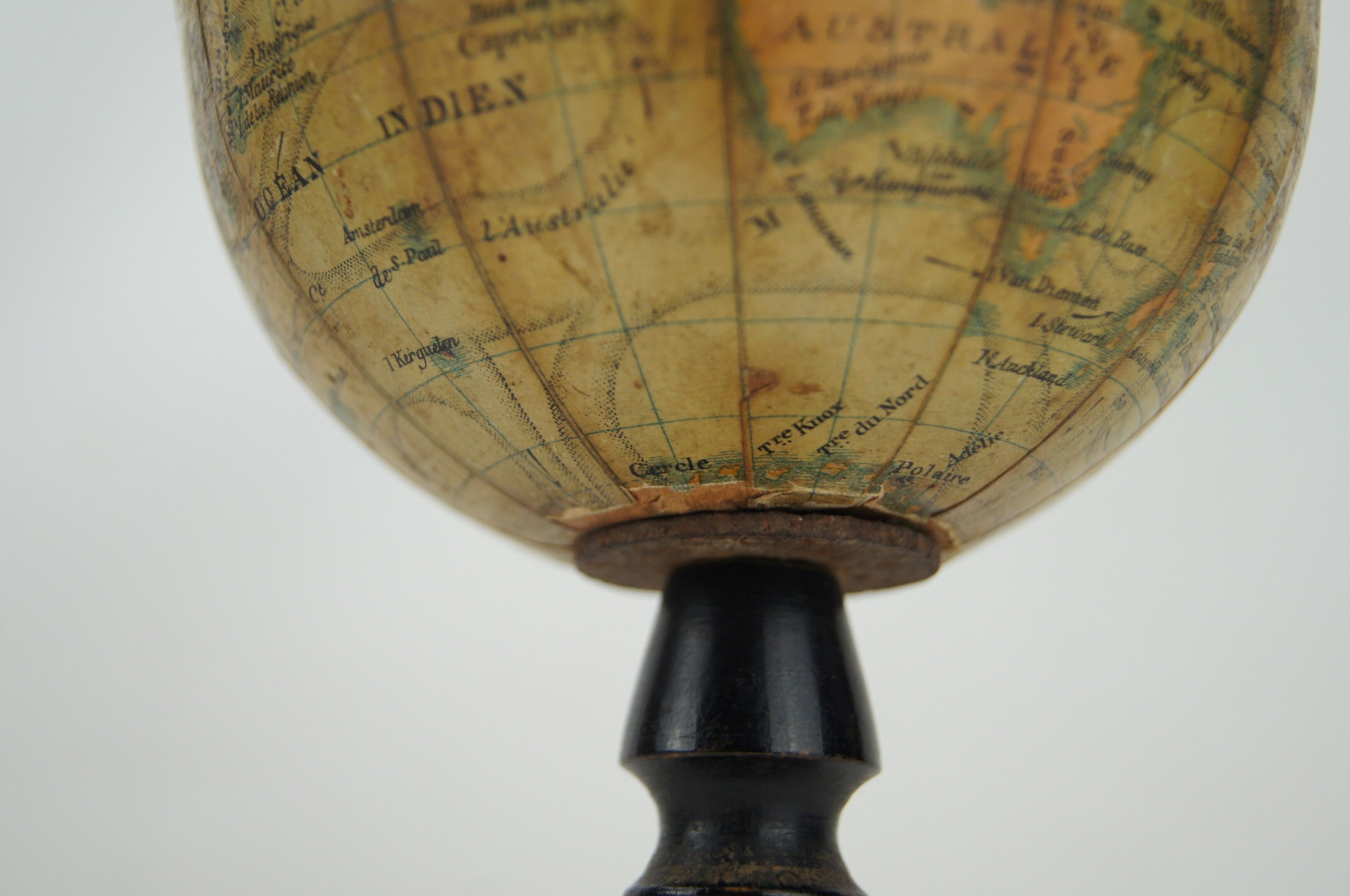 Globe on turned and blackened wooden base