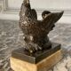 Eagle and serpent, bronze inkwell on a marble base.