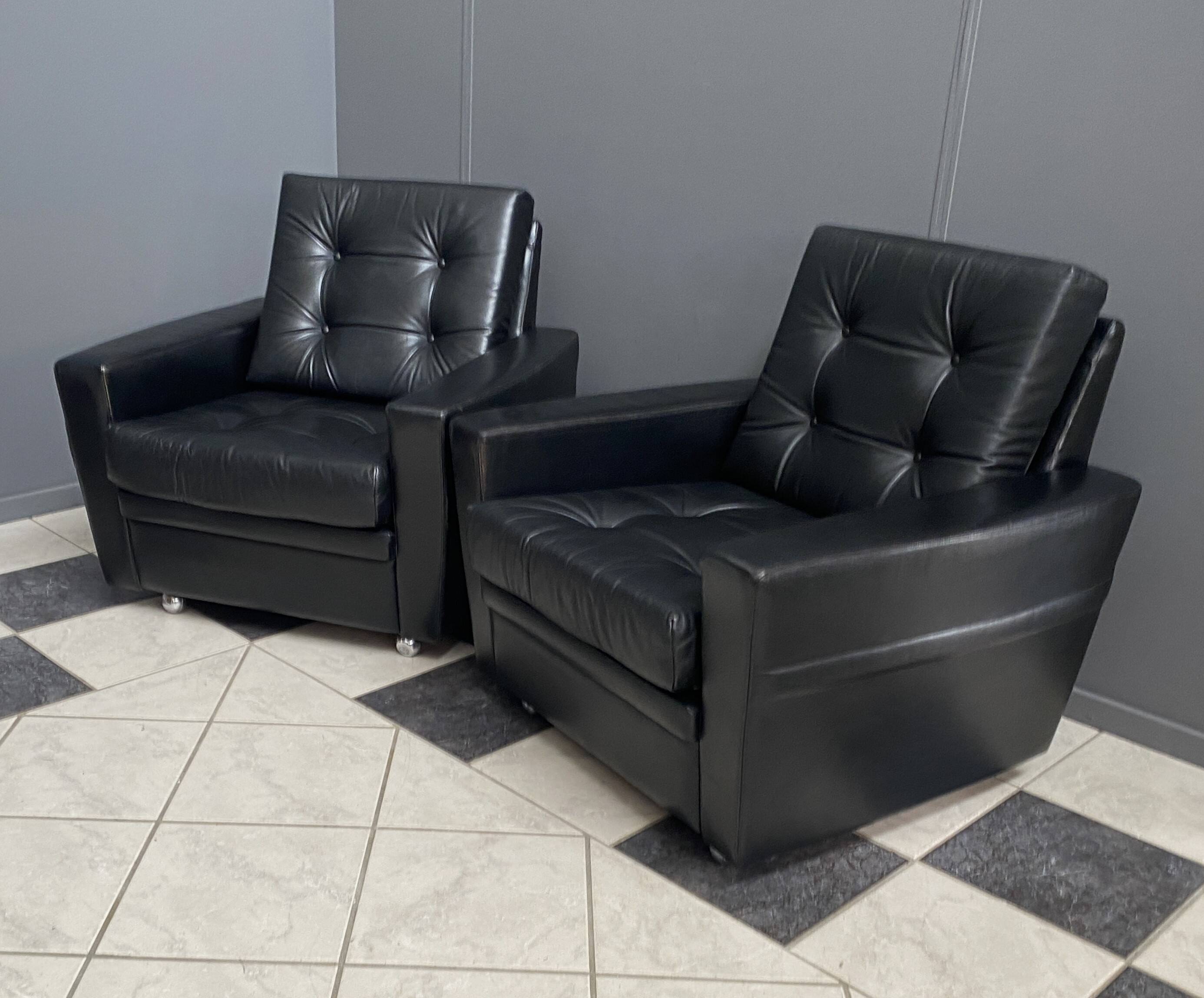 2 Black leather arm chairs 1960s on wheels