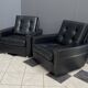 2 Black leather arm chairs 1960s on wheels